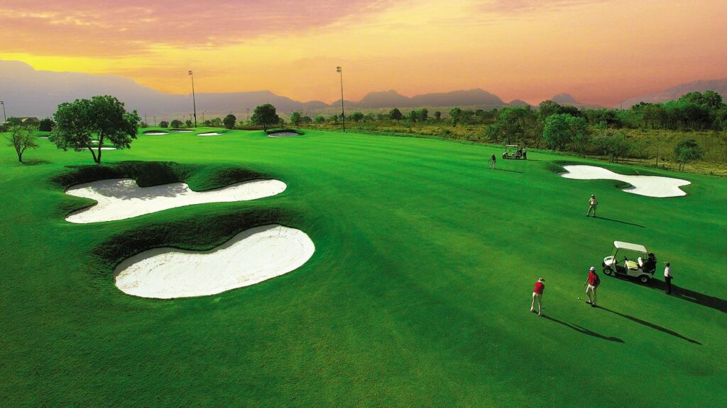 Nestled amidst the picturesque Sahyadri Ranges of the Western Ghats, Aamby Valley Golf Resort promises an unparalleled golfing experience. This sprawling 250-acre course, cradled by rolling hills and shimmering lakes, offers breathtaking scenery that will tantalize your senses even as you tee off.